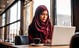 Businesswoman in hijab working on laptop