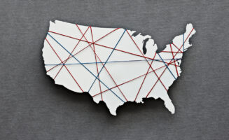 A map of the United States, divided by threads representing different political parties.