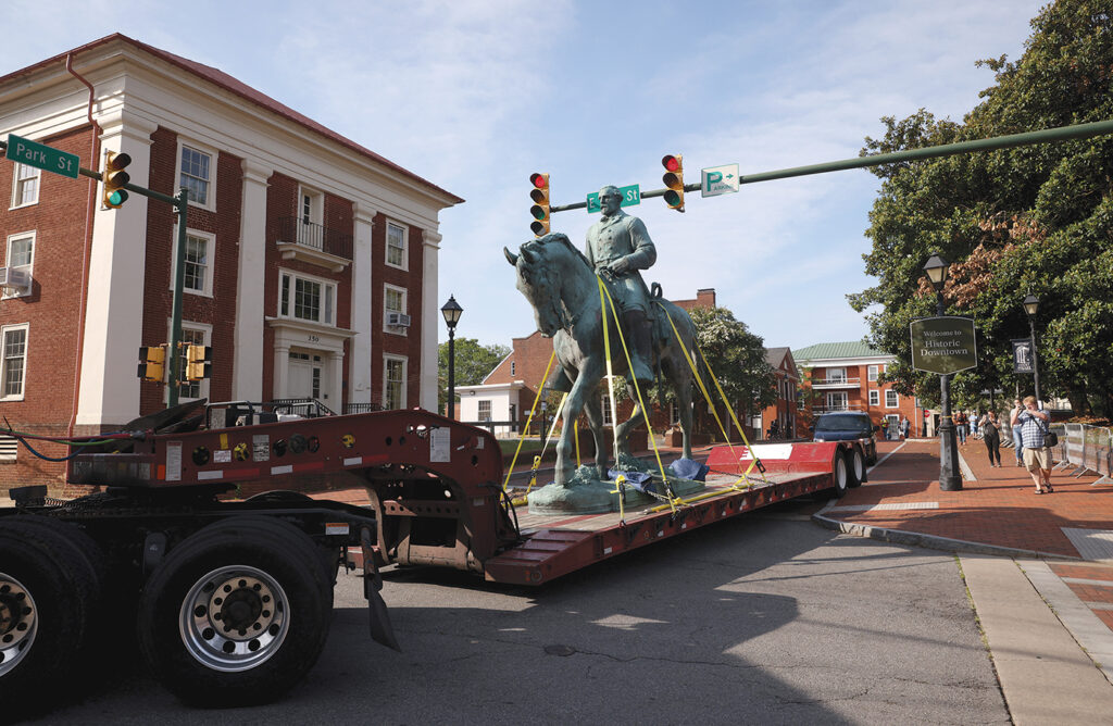A statue of Confederate Gen. Robert E. Lee is hauled away on a large truck from Market Street Park in Charlottesville, Virginia, on July 10, 2021.
