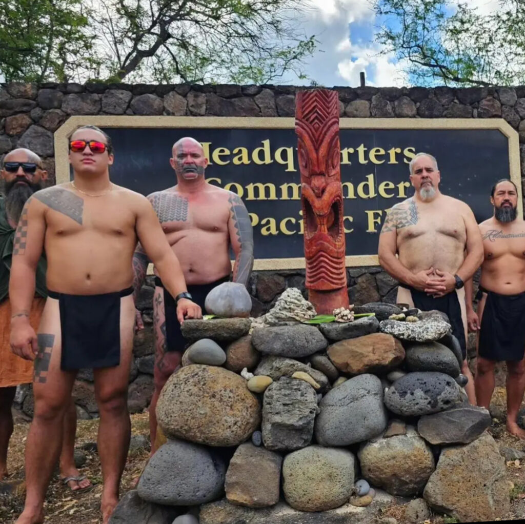 Kalehua Krug (third from left) and other members of Kaʻohewai, a coalition of Hawaiian organizations, at the ceremonial koʻa, or fishing shrine, that was erected in front of the U.S. Pacific Fleet command headquarters in honor of Kāneikawaiola, the God of living or healing waters.