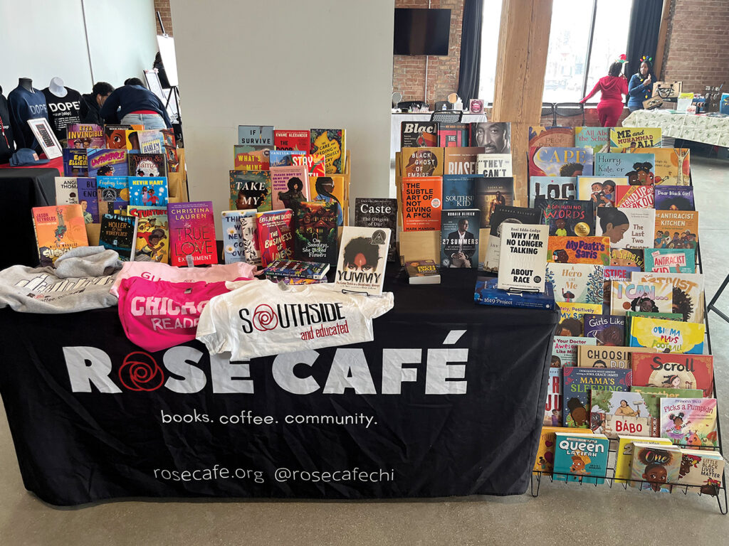 A photograph of the Rose Café table at a local Chicago pop-up. The table and displays are filled with books about Black characters. 
