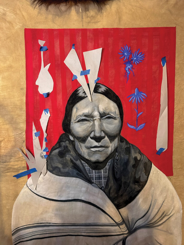 A photograph of a painting in progress. Strips of white paper block out sections of the painting, which is a tribe matriarch against a red background with blue floral details. 