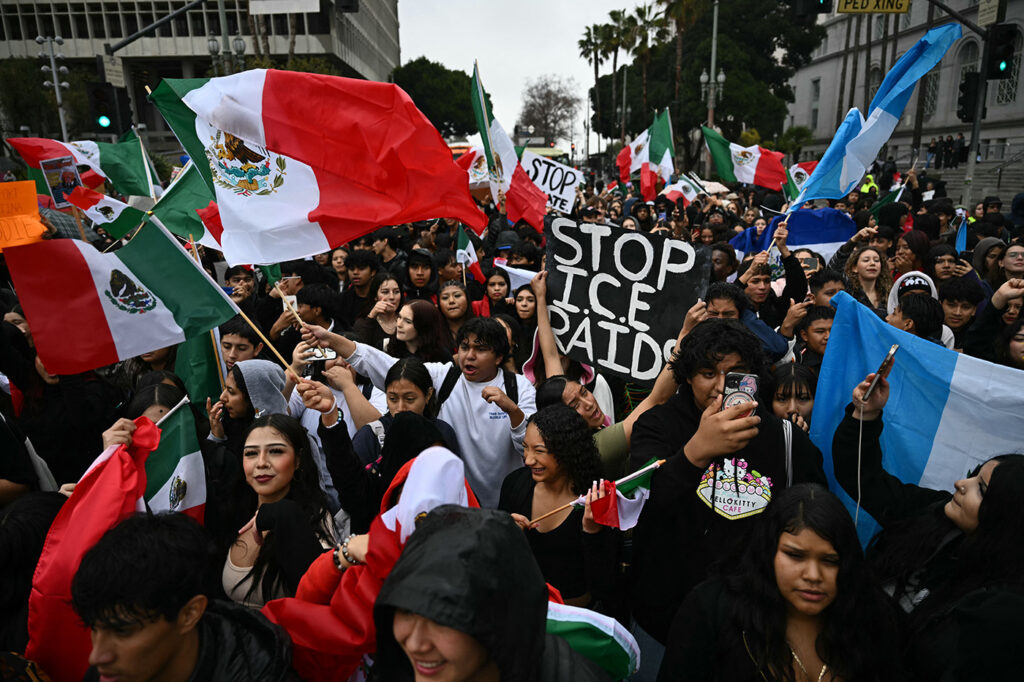 On Feb, 5, 2025, students gathered outside of city hall in Los Angeles to protest Donald Trump and his anti-immigration stance as part of a national protest. They hold Mexican flags and a sign that says "Stop ICE Raids"