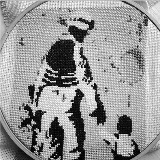 Embroidered image of a soldier and child by Betsy Greer.