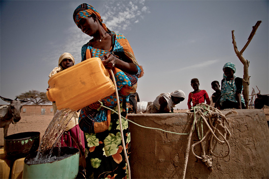 Refilling water container. Photo by Oxfam.