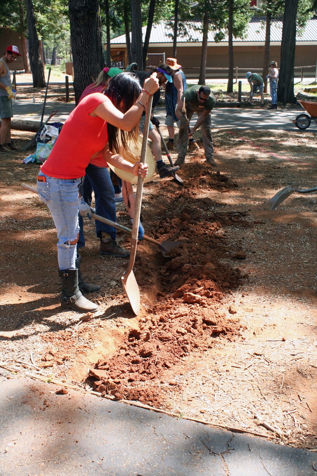 <p>Volunteers dig a drainage ditch at the school. Photo by Dani Burlison.</p>