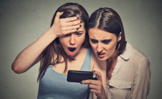Women Looking at Phone App photo from Shutterstock