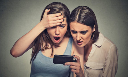 Women Looking at Phone App photo from Shutterstock