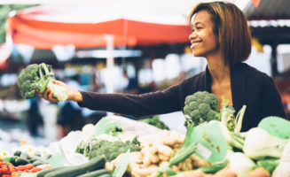 Woman selling vegetables by Shutterstock