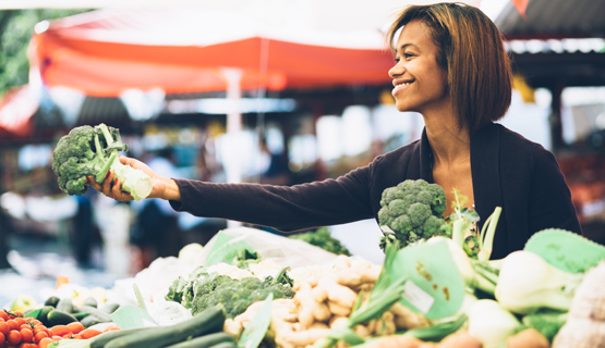 Woman selling vegetables by Shutterstock