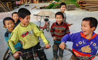 Chinese boys laughing in Guizhou province. Photo by Grigvovan / Shutterstock.com.